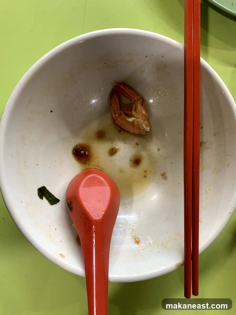 Empty Bowl with Shrimp Tail and Chopsticks