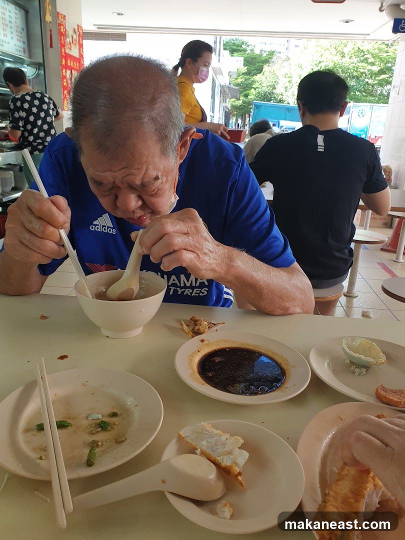 Man eating at a food stall