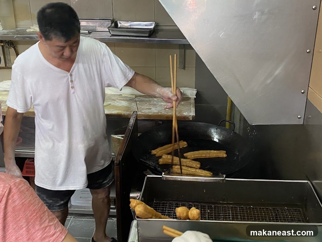 Man Frying Dough Sticks
