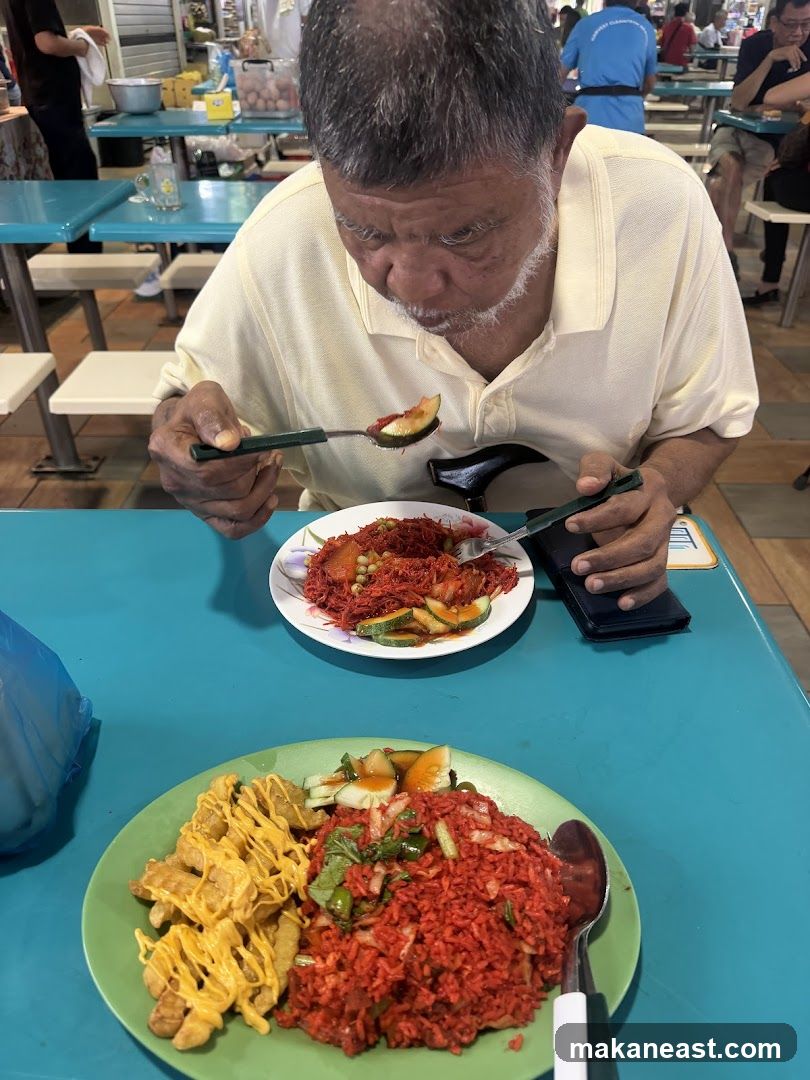 Man Eating Food at a Hawker Center