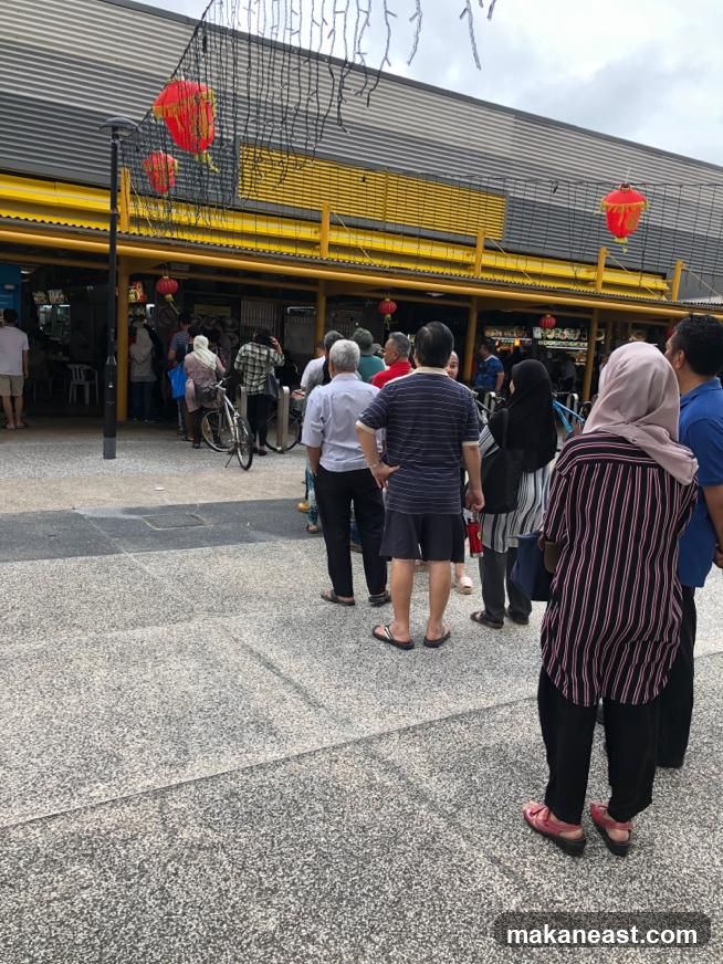 People queuing at an outdoor food stall