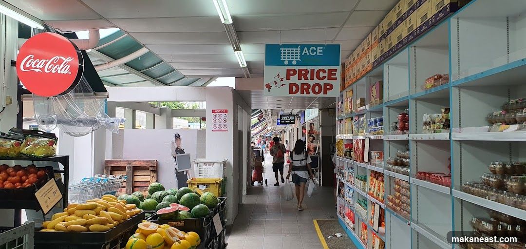 Supermarket aisle with produce and shelves