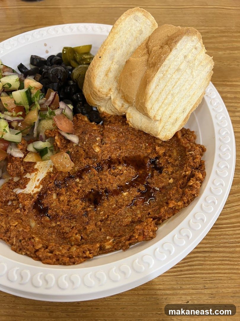 Plate of Food with Dip, Salad, Olives, and Bread