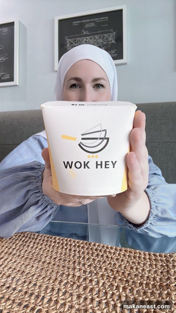 Person holding a Wok Hey food container