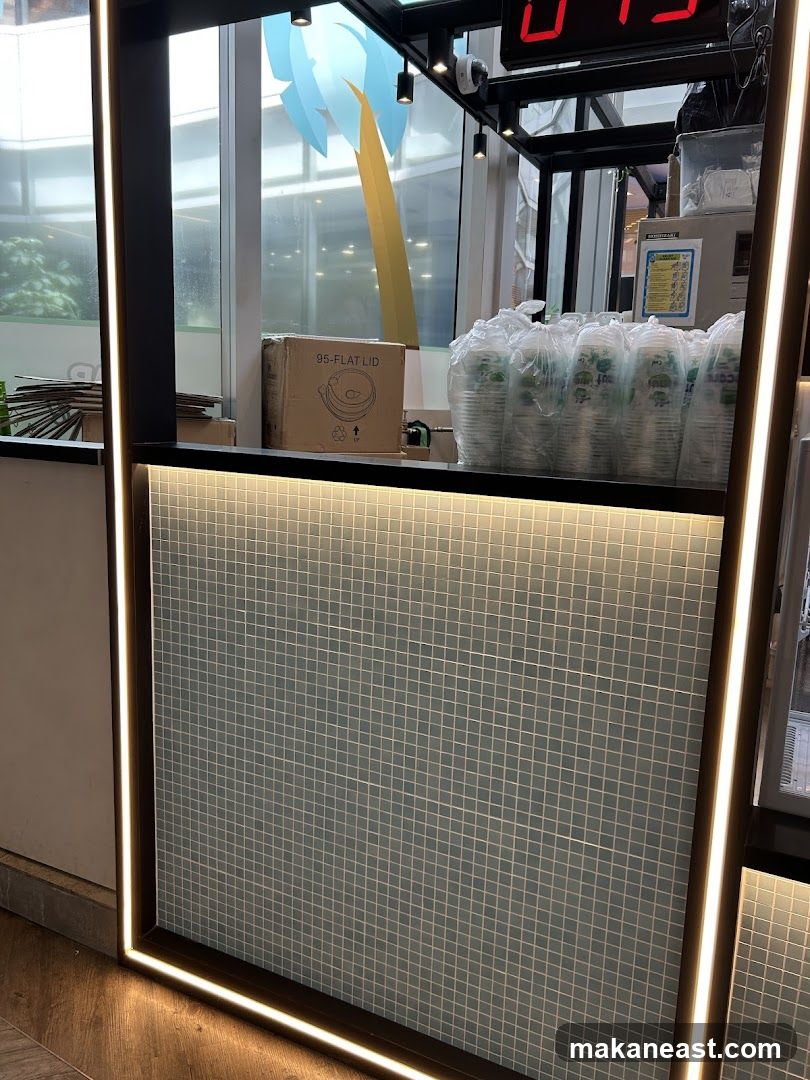 Counter with stacked cups and a box of lids