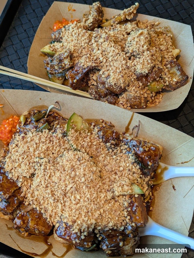 Two plates of food topped with crushed peanuts