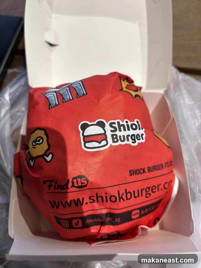 Burger wrapped in branded paper