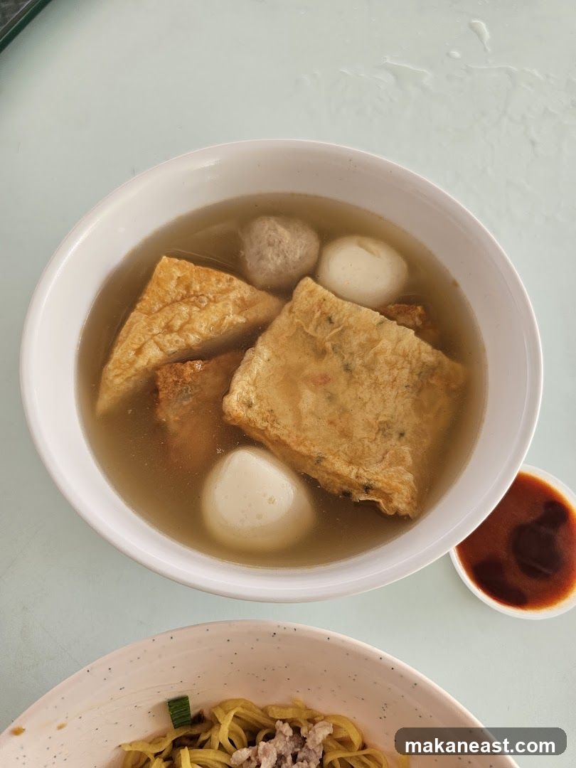 Bowl of soup with fish cakes and meatballs