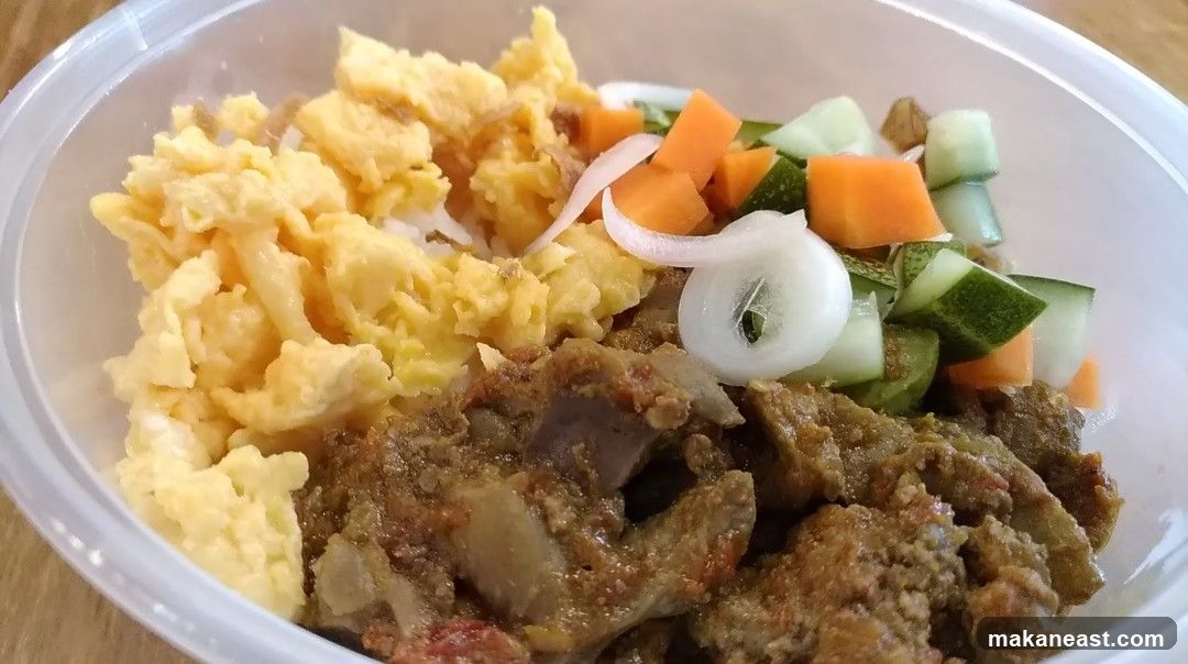 Rice bowl with scrambled eggs, meat, and vegetables