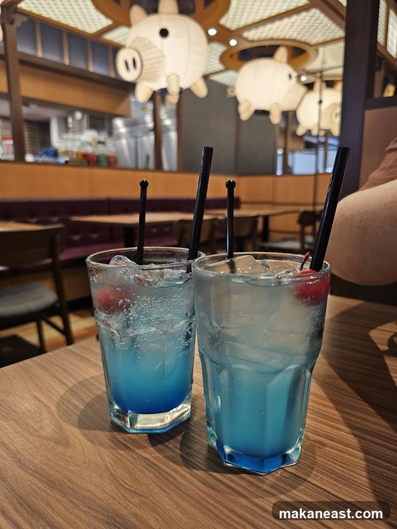 Two blue cocktails on a wooden table