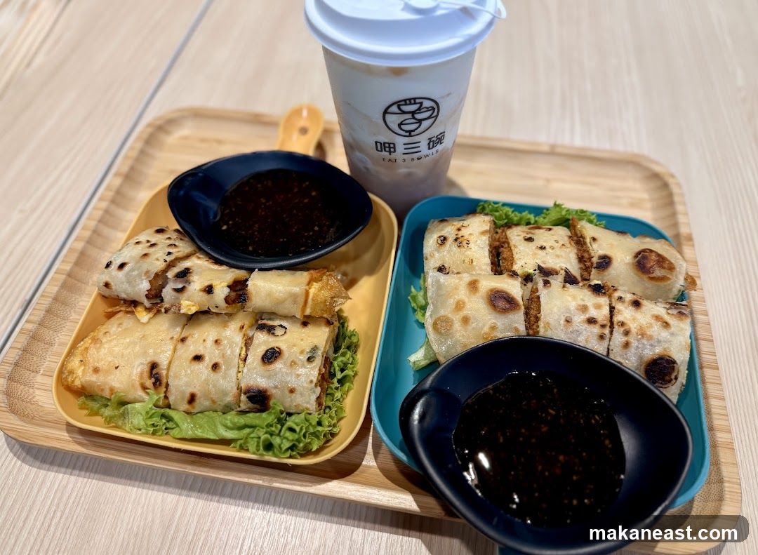 Rolled crepes with dipping sauce and a drink