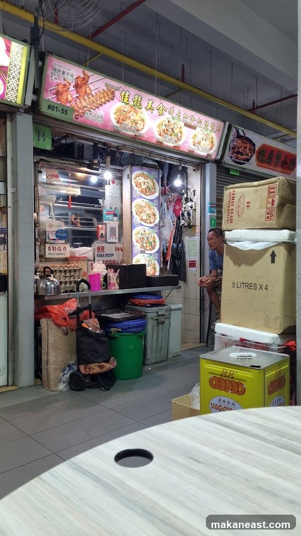 Food Stall with Menu and Seated Man