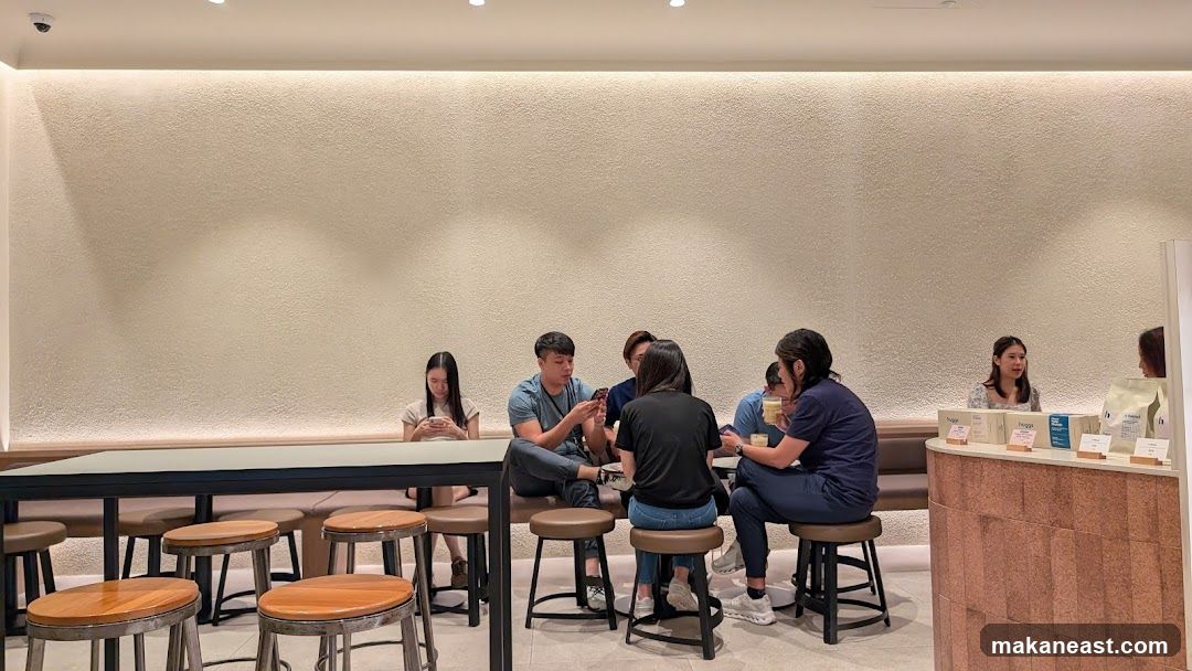 People sitting at tables in a cafe