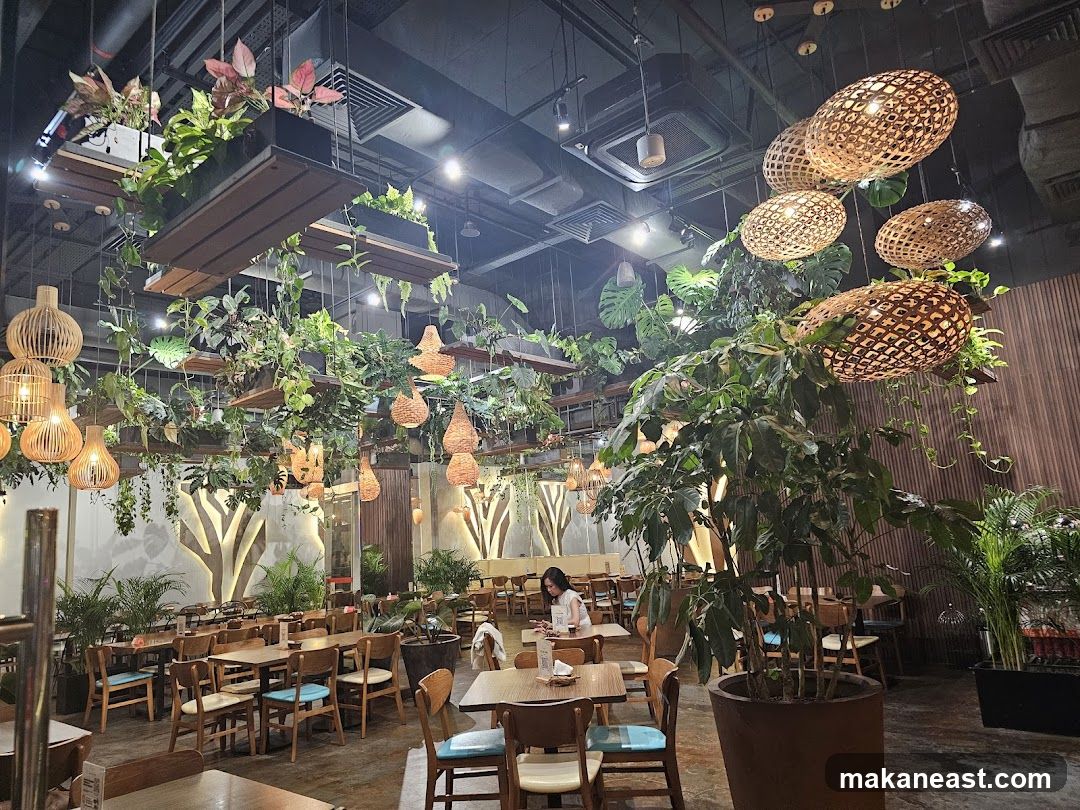 Restaurant Interior with Lush Greenery and Woven Light Fixtures