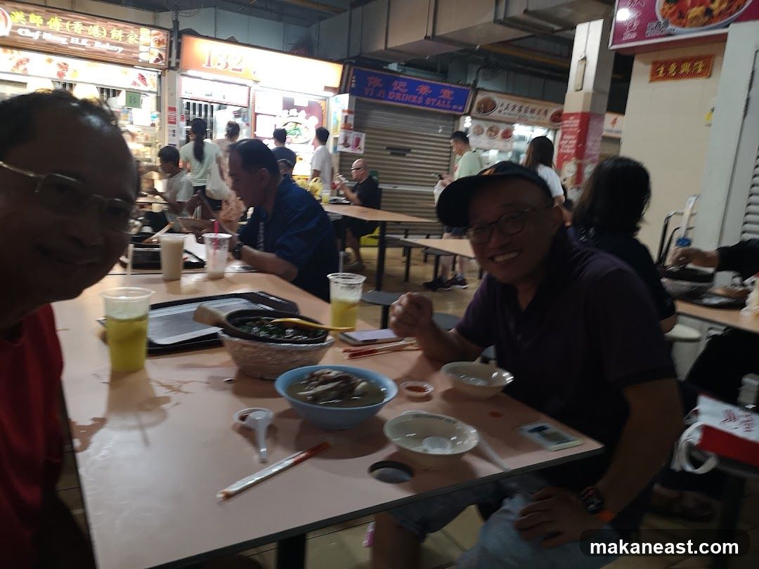 People Eating at a Food Stall