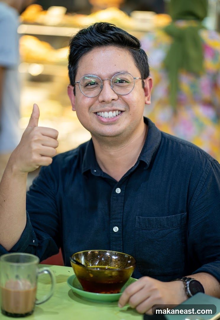 Man giving a thumbs up with food and drink