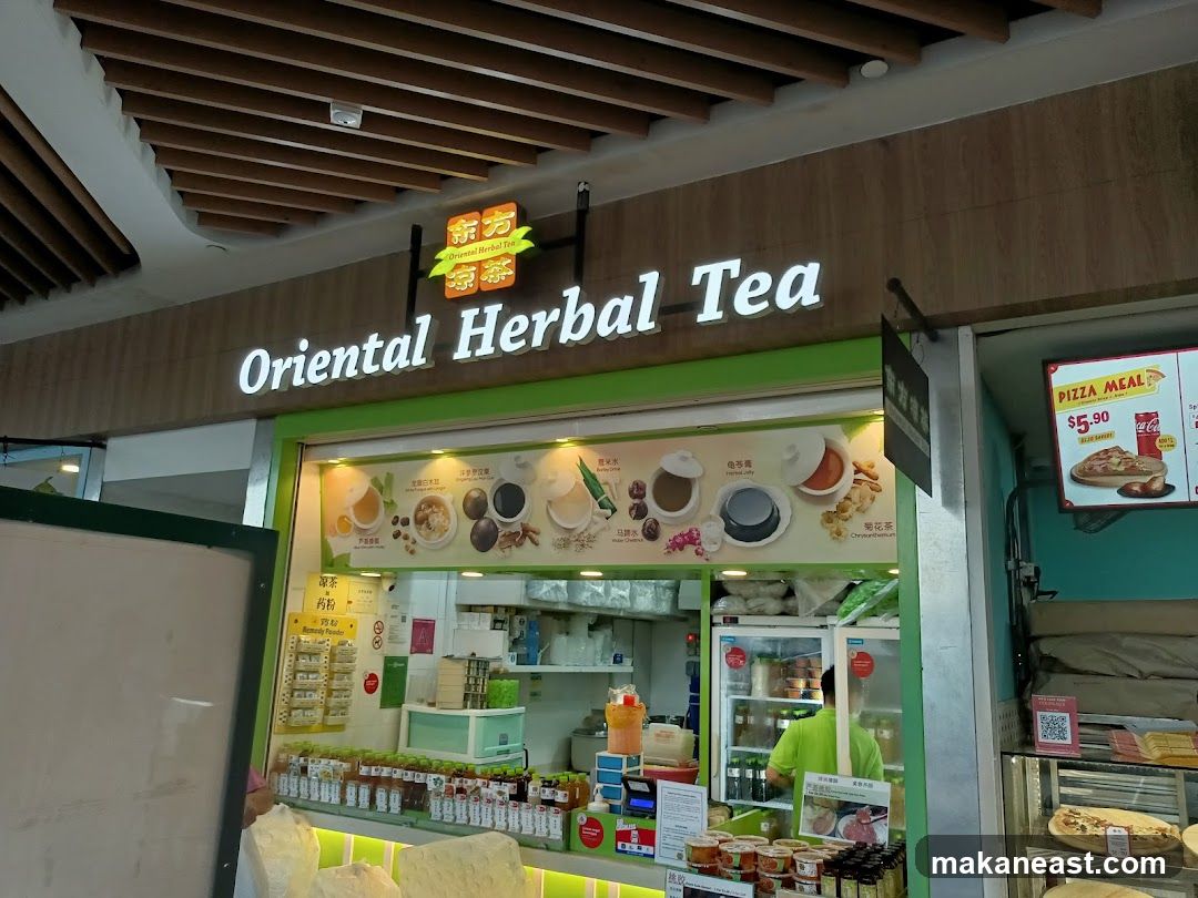 A storefront for Oriental Herbal Tea with a prominent sign. The shop displays various herbal drinks and food items. To the right, a pizza meal advertisement is visible.