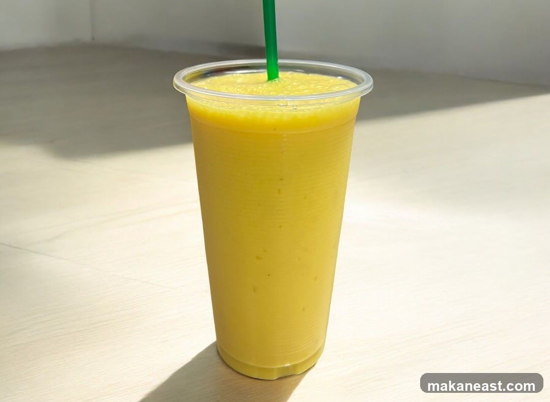 Yellow Smoothie in a Plastic Cup