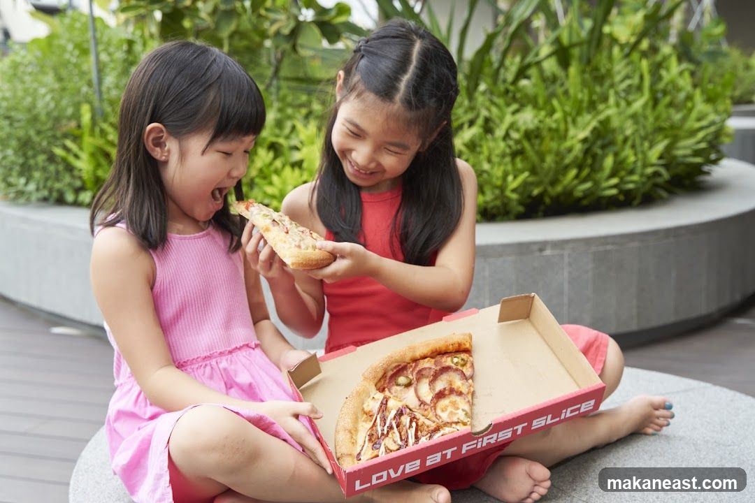 Two girls eating pizza