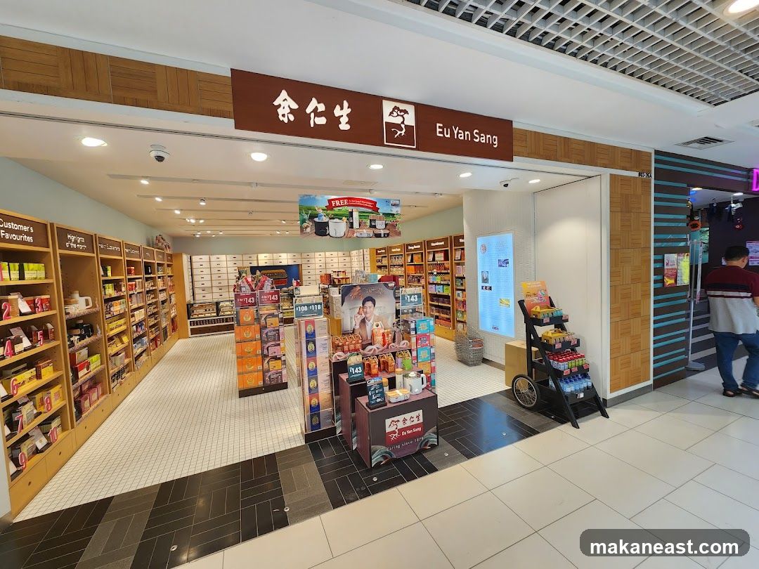 The image shows the exterior of a Eu Yan Sang store. The store has a clean and organized interior with shelves stocked with various products. A sign above the entrance reads "Eu Yan Sang" in English and Chinese. There are also promotional displays and a cart with products near the entrance. A person is seen walking into the store on the right side of the image.