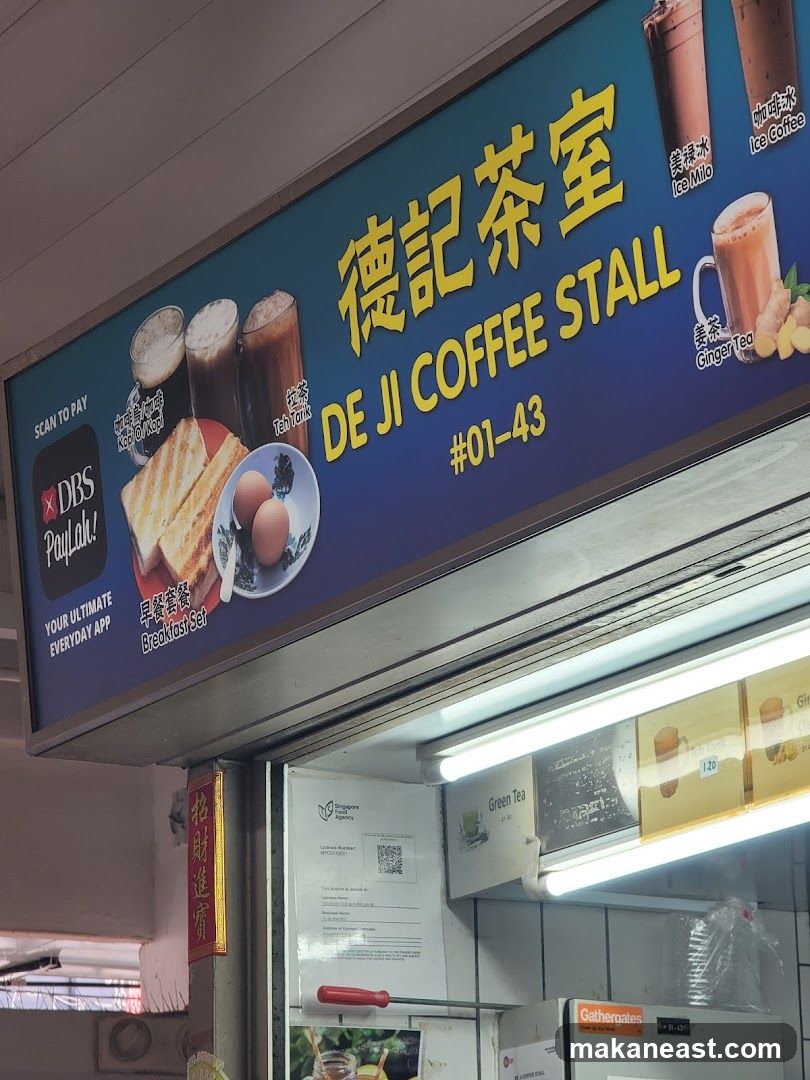 A blue and yellow sign for De Ji Coffee Stall displays various drinks and food items. Pictured are Ice Milo, Ice Coffee, Teh Tarik, Ginger Tea, and a breakfast set with toast and eggs. The stall number #01-43 is also visible. Below the sign, a Singapore Food Agency license is displayed.