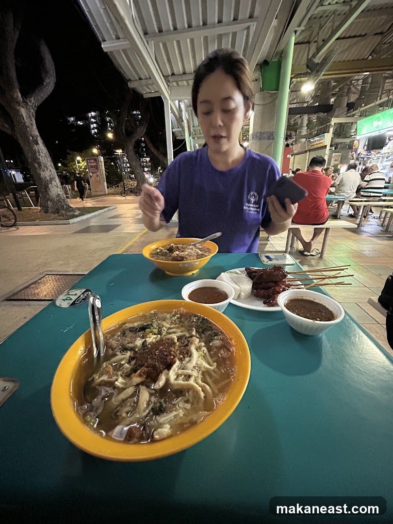 Woman Eating Noodles at Outdoor Food Stall