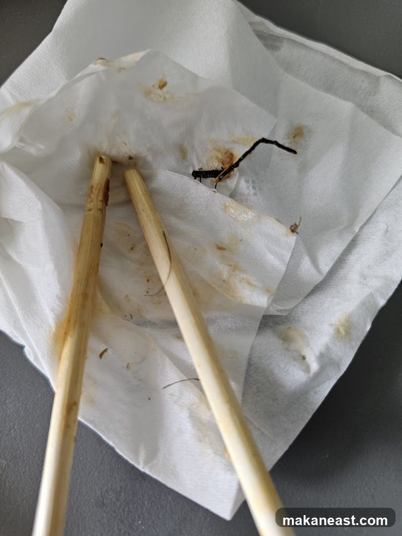 Chopsticks and debris on paper towel
