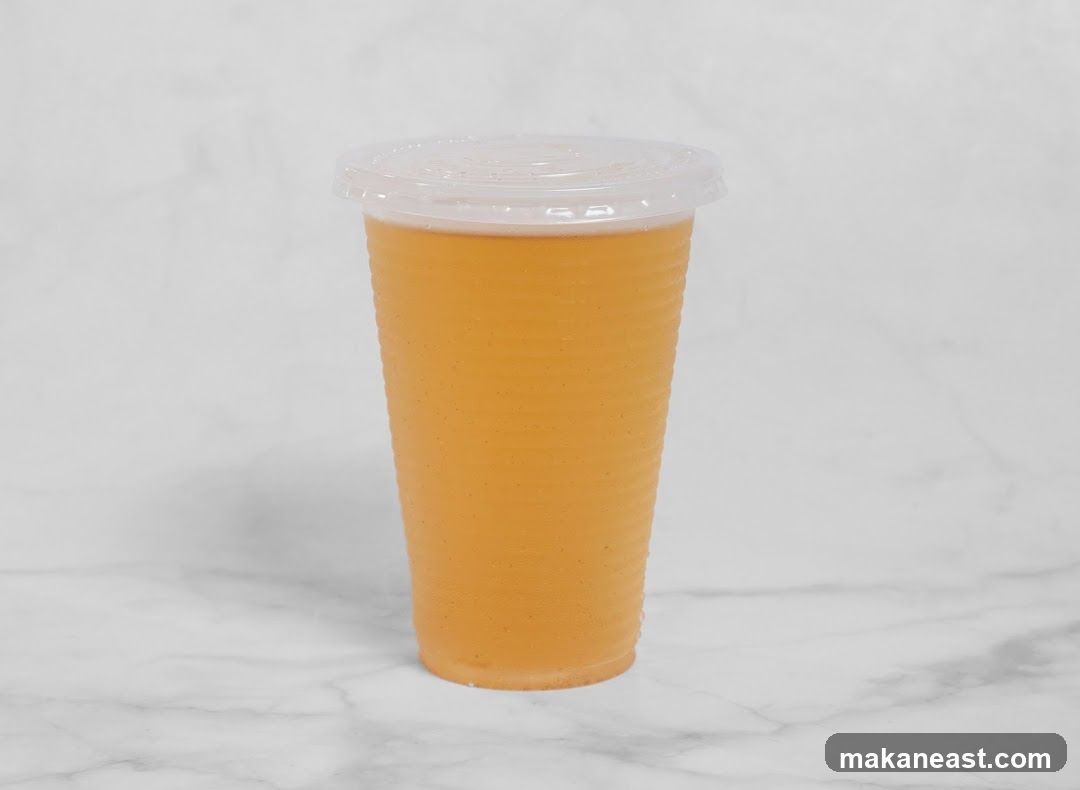 Orange beverage in a plastic cup