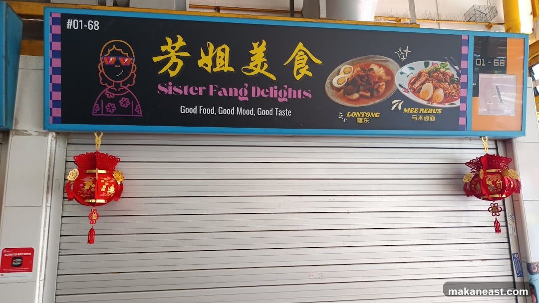 A storefront with a blue and yellow sign above a closed metal shutter. The sign features the business name "Sister Fang Delights" in English and Chinese, along with images of two dishes: Lontong and Mee Rebus. The slogan "Good Food, Good Mood, Good Taste" is also displayed. Two red lanterns hang in front of the shutter.