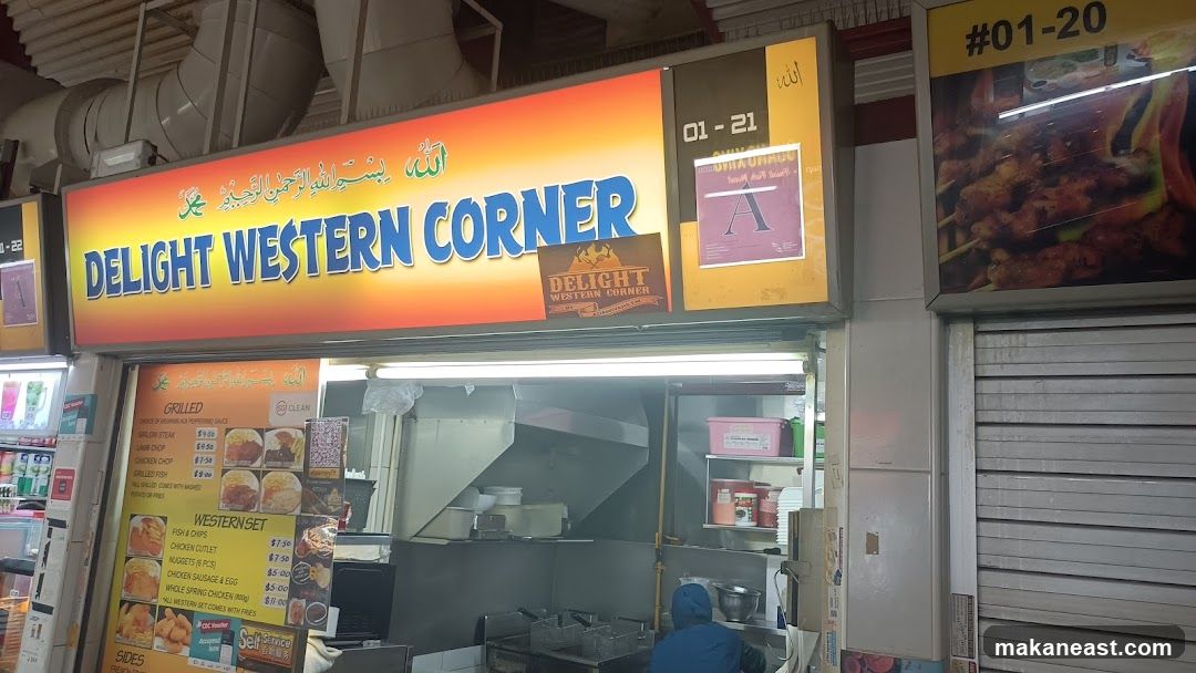 A brightly lit sign with the words "DELIGHT WESTERN CORNER" in blue and yellow lettering against an orange and yellow gradient background. Below the sign is a menu board displaying various grilled items and western sets. The stall appears to be in a food court or hawker center.