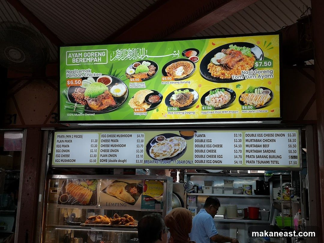 A menu board displaying various Malay and Singaporean dishes.