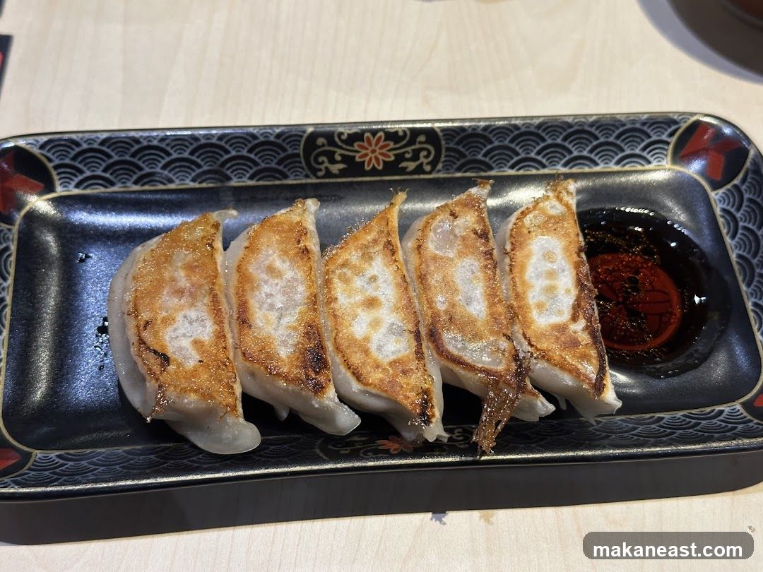 Pan-fried dumplings with dipping sauce