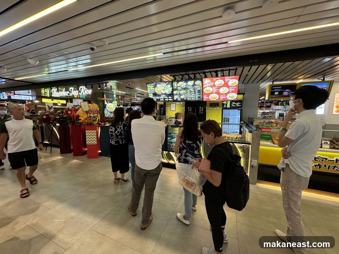 People queuing at a food stall
