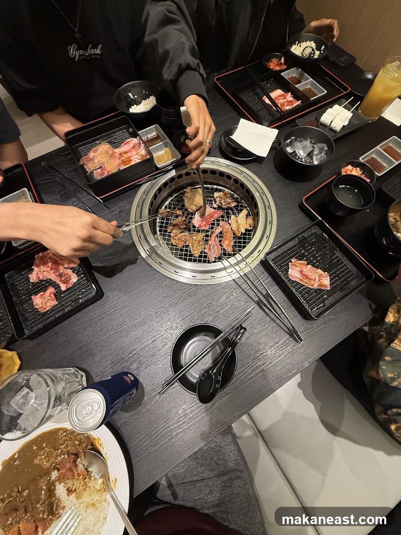 People grilling meat at a table