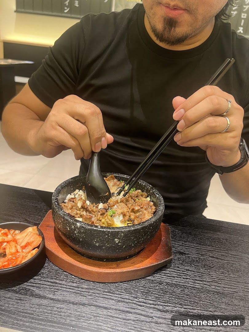 Person eating a stone bowl dish