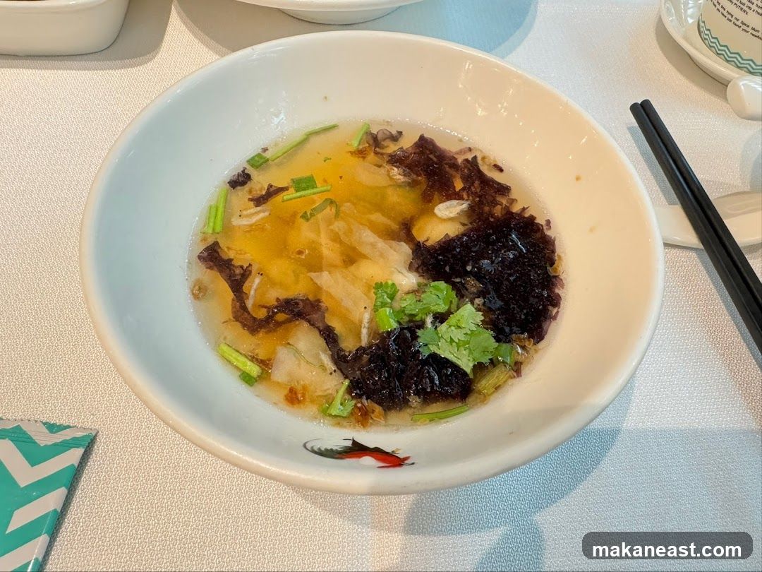 Bowl of soup with seaweed and herbs