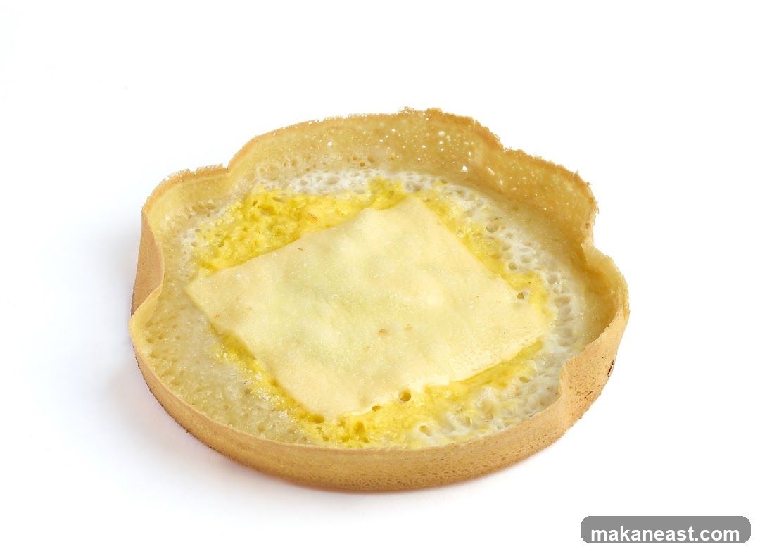 A close-up of a pancake with cheese
