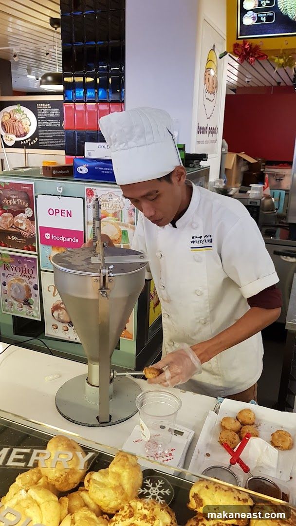 Baker making cream puffs