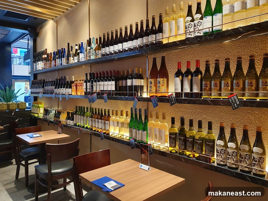 Wine bottles on shelves with tables and chairs