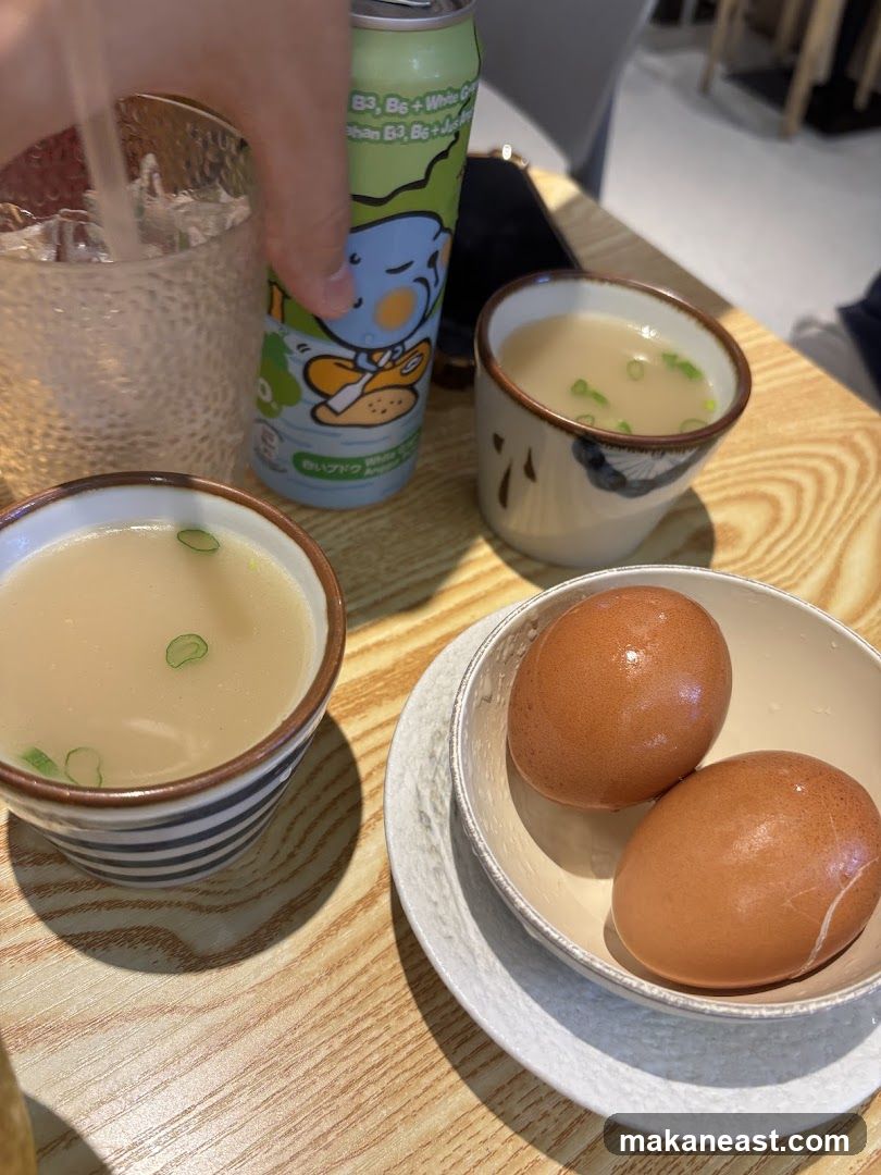 Two bowls of soup and two eggs