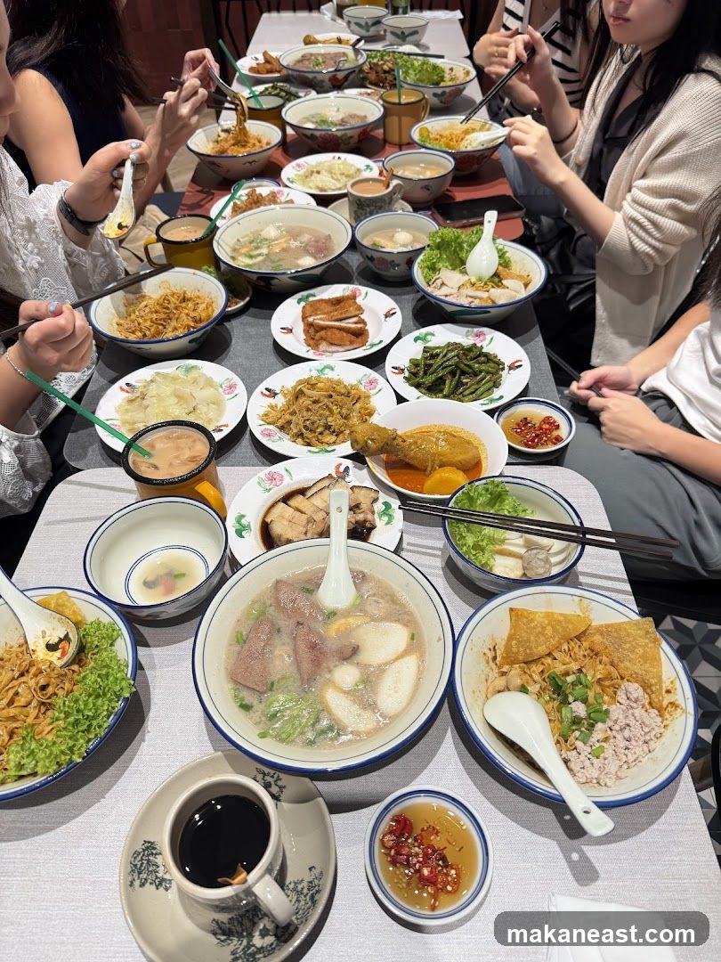 A table full of various noodle dishes and side dishes.
