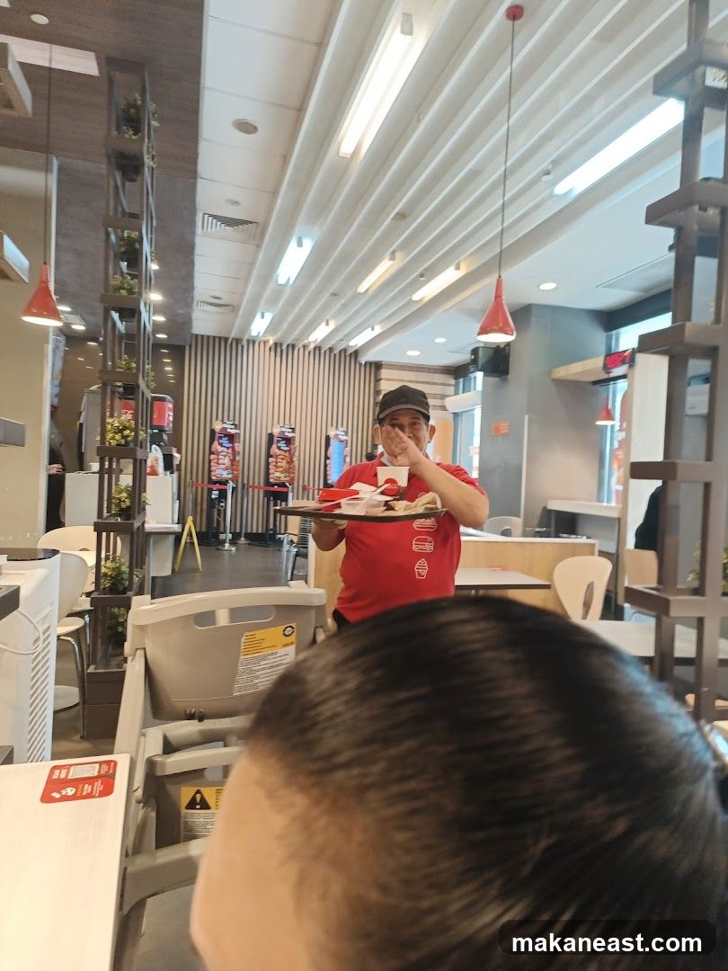 Staff member carrying food tray