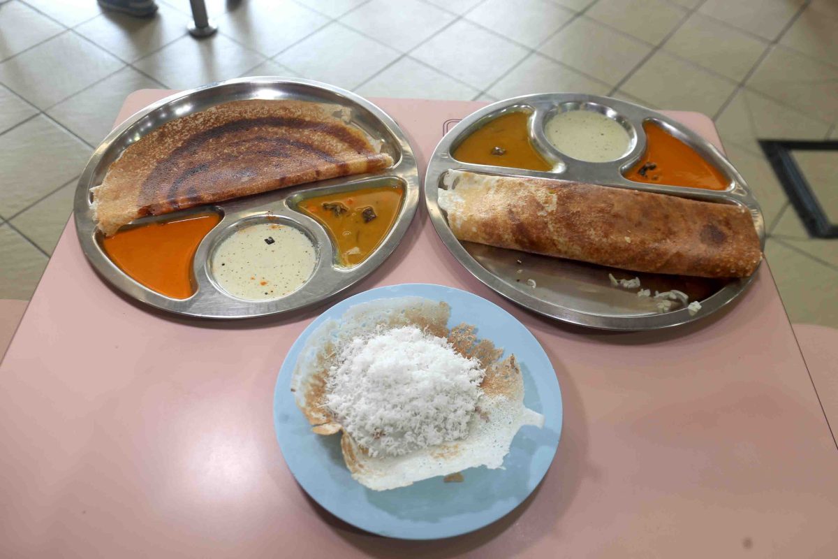 Thosai and coconut appam spread on a hawker table at Rajarani Thosai in Tampines Round Market, a Michelin-recognised South Indian hawker stall in east Singapore