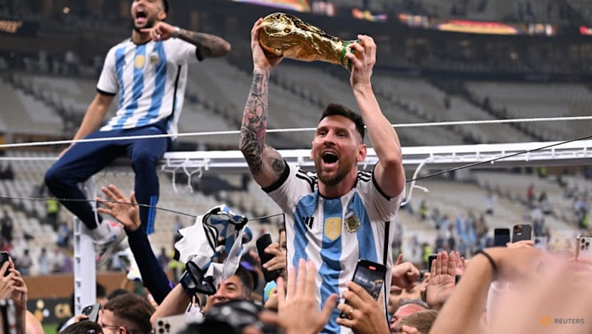 Lionel Messi lifting the FIFA World Cup trophy, the kind of moment fans at East Singapore community screenings are watching for